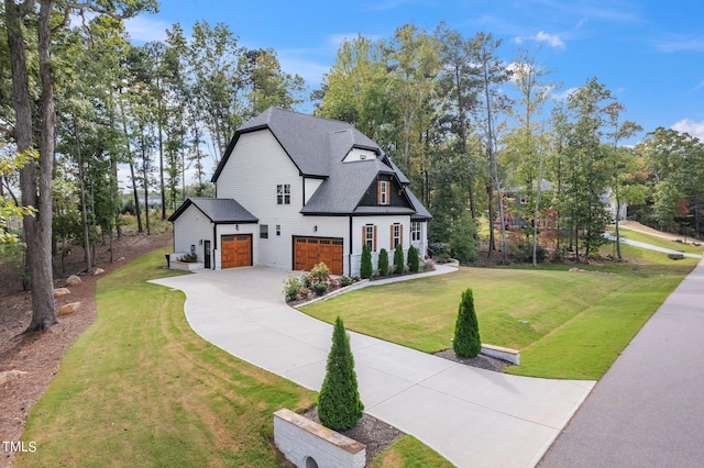 view of front of house featuring a front lawn and a garage