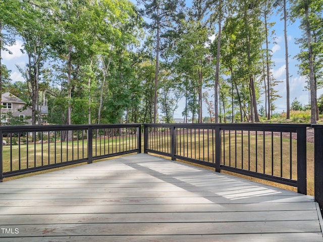 wooden terrace featuring a lawn