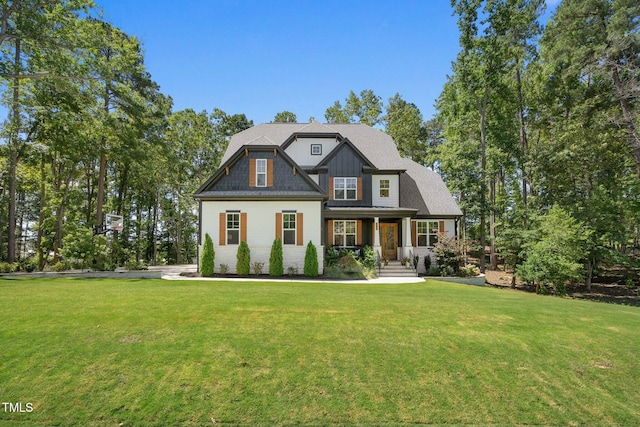 view of front of home with covered porch and a front lawn