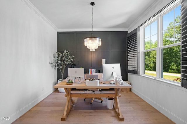 office area with crown molding, light wood-type flooring, and an inviting chandelier