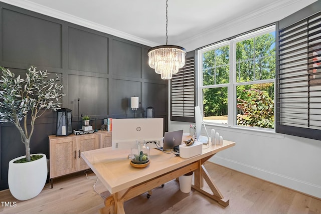 office area with crown molding, light wood-style floors, a wealth of natural light, and a decorative wall