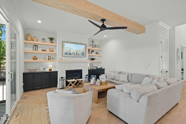 living area featuring recessed lighting, ornamental molding, a brick fireplace, light wood-type flooring, and beamed ceiling