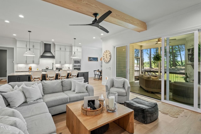 living room featuring ornamental molding, light wood finished floors, beam ceiling, and recessed lighting