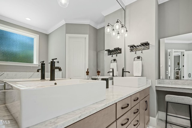 bathroom with crown molding, a sink, and double vanity