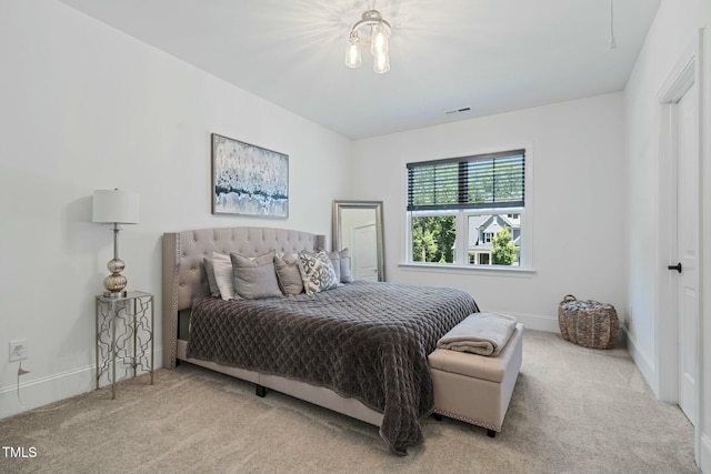 bedroom featuring carpet floors, visible vents, and baseboards