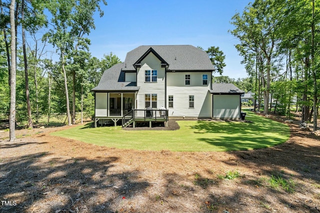 back of property with a shingled roof and a yard