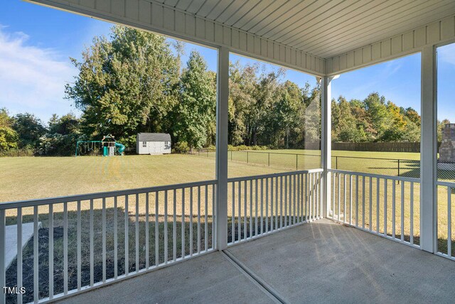 unfurnished sunroom with wood ceiling and plenty of natural light