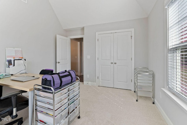 carpeted home office with lofted ceiling and a wealth of natural light