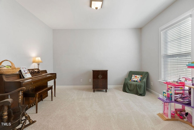 sitting room featuring light carpet