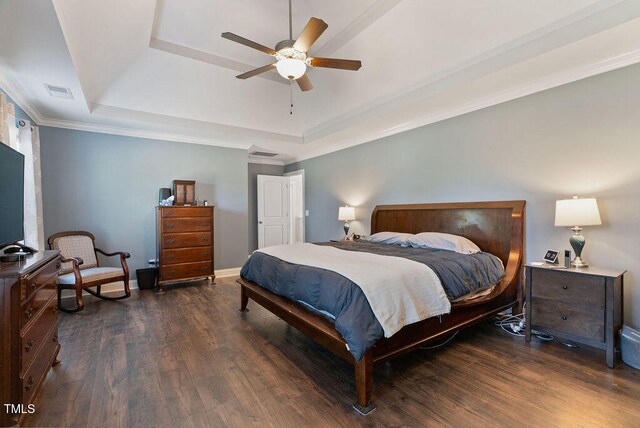 bedroom featuring ornamental molding, ceiling fan, a tray ceiling, and dark hardwood / wood-style flooring