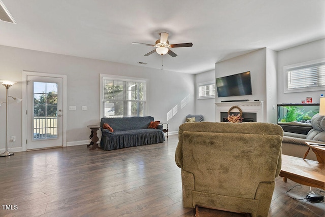 living room with ceiling fan and dark hardwood / wood-style flooring