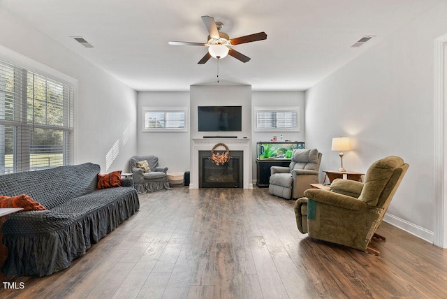 living room featuring ceiling fan, dark hardwood / wood-style flooring, and a wealth of natural light