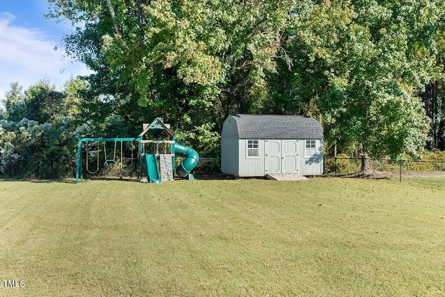 view of yard with a playground and a storage shed