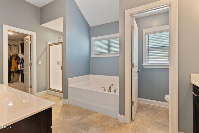 full bathroom featuring independent shower and bath, vanity, and a healthy amount of sunlight