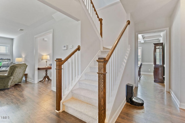 staircase featuring hardwood / wood-style flooring and a healthy amount of sunlight