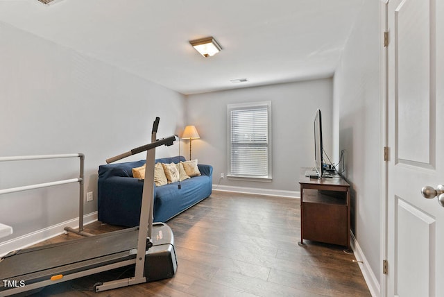 workout area with dark hardwood / wood-style floors