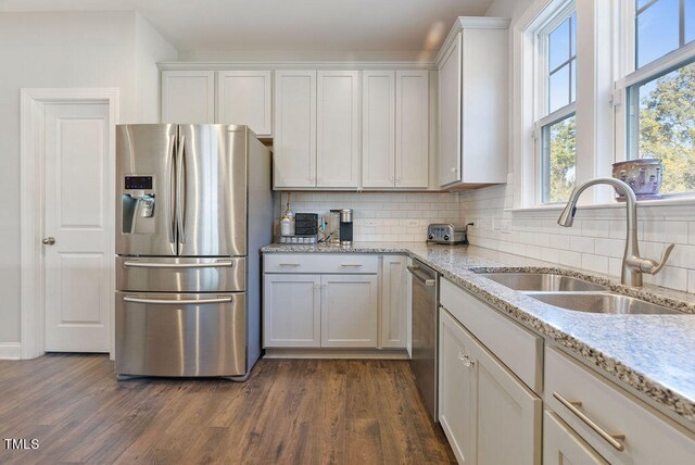 kitchen featuring dark hardwood / wood-style flooring, stainless steel appliances, and white cabinets