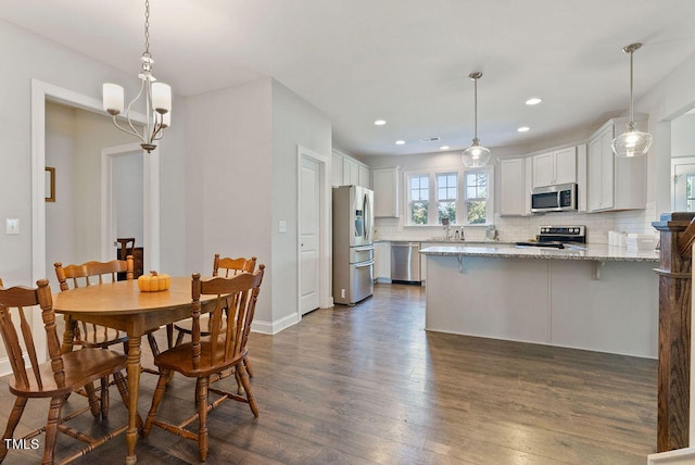 dining room with a chandelier and dark hardwood / wood-style flooring