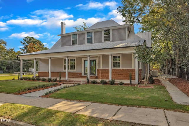 view of front of property with covered porch and a front lawn