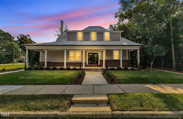 view of front of home featuring a yard and a porch