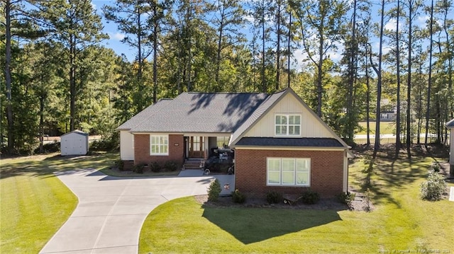 view of front of house with a front lawn and a shed