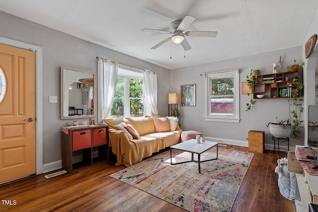 living room with ceiling fan and dark hardwood / wood-style flooring