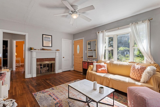 living room featuring a brick fireplace, ceiling fan, and dark hardwood / wood-style flooring