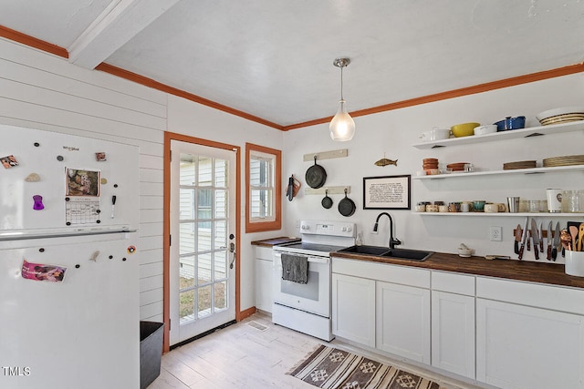 kitchen with pendant lighting, sink, a wealth of natural light, and white appliances