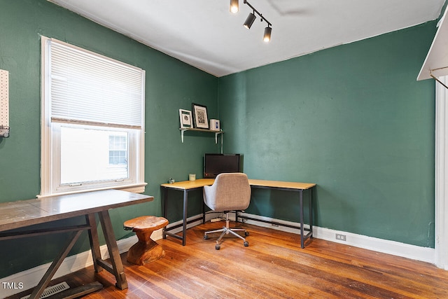 office area with track lighting and wood-type flooring