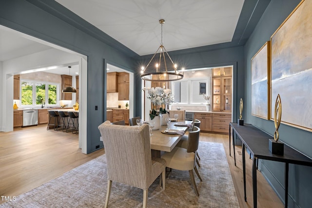 dining room featuring an inviting chandelier and light wood-type flooring