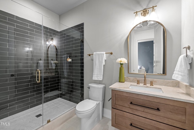bathroom featuring a stall shower, toilet, vanity, and tile patterned floors