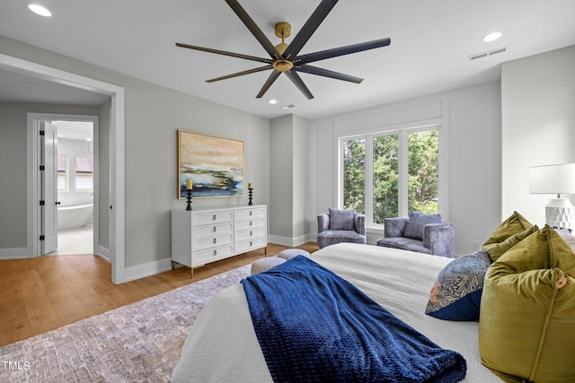 bedroom featuring multiple windows, baseboards, wood finished floors, and recessed lighting