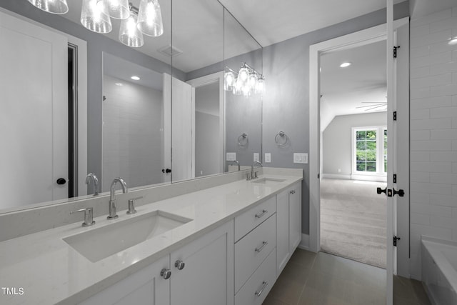 bathroom with tile patterned floors, a tub, vanity, and ceiling fan