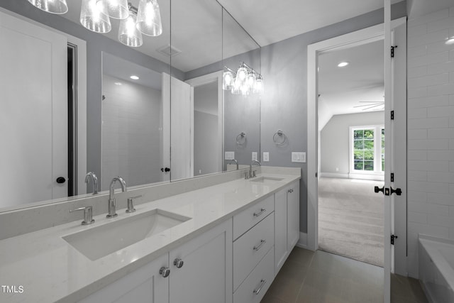 full bath with lofted ceiling, double vanity, recessed lighting, tile patterned flooring, and baseboards