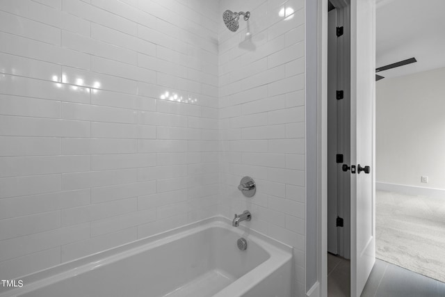 full bath featuring baseboards, shower / bath combination, and tile patterned floors