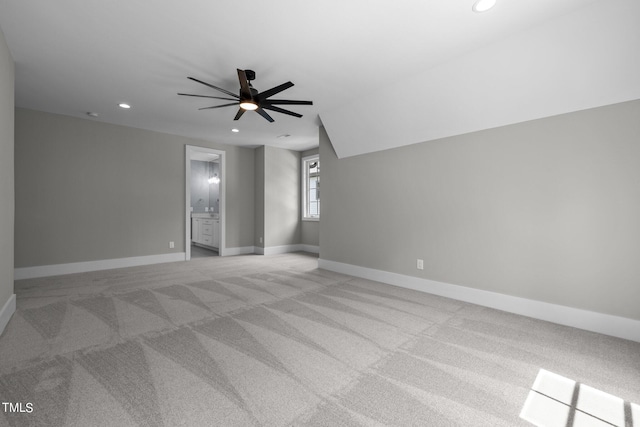spare room with recessed lighting, light carpet, a ceiling fan, and baseboards