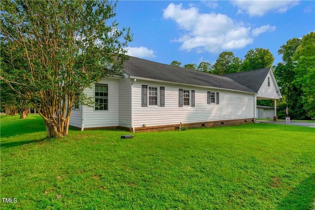 view of side of home with a lawn