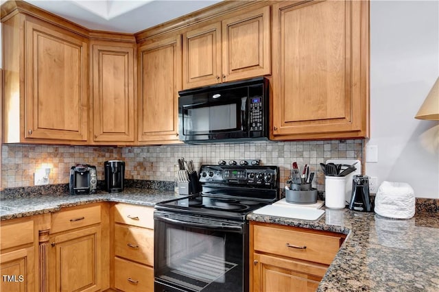 kitchen featuring black appliances, backsplash, and dark stone counters