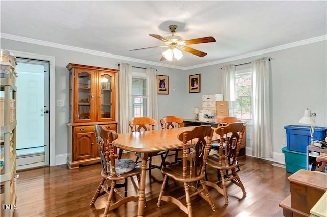 dining area featuring crown molding, dark wood-type flooring, and ceiling fan