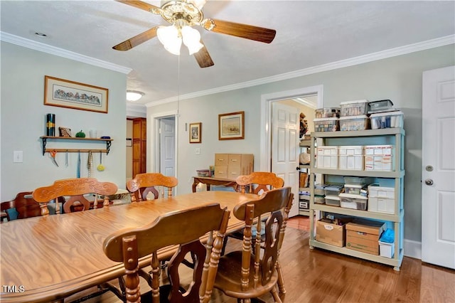 dining room featuring ornamental molding, hardwood / wood-style flooring, and ceiling fan