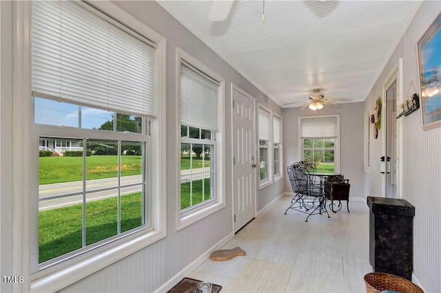 sunroom featuring ceiling fan and a healthy amount of sunlight