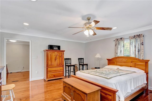 bedroom with ornamental molding, light wood-type flooring, and ceiling fan