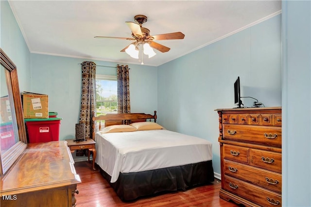 bedroom with crown molding, ceiling fan, and dark hardwood / wood-style flooring