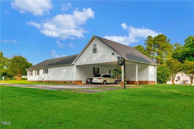 back of property with a yard and a carport