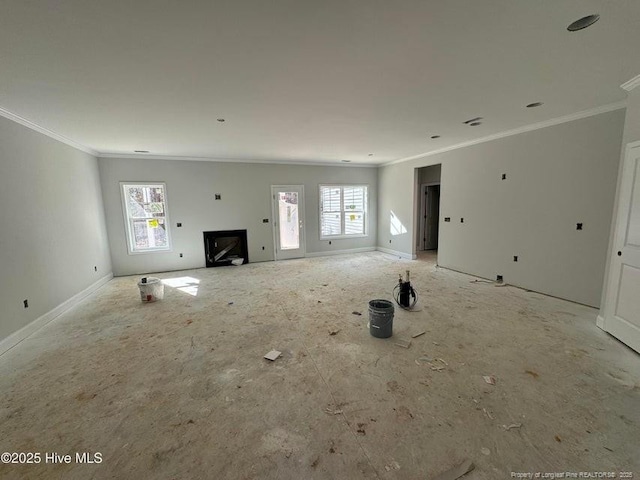 unfurnished living room with ornamental molding