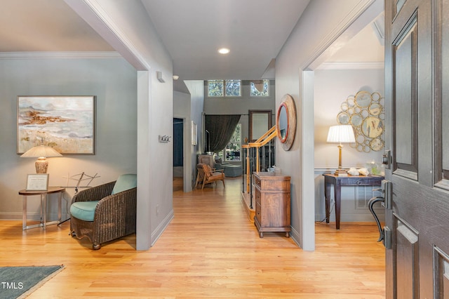 foyer with crown molding and light wood-type flooring