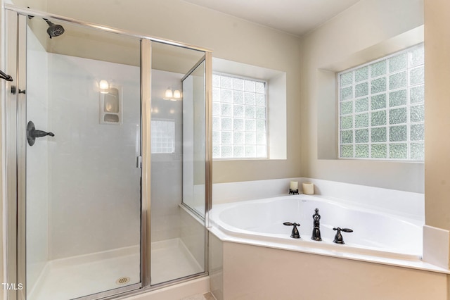 bathroom with a garden tub and a shower stall