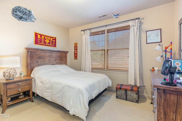 carpeted bedroom with baseboards and visible vents