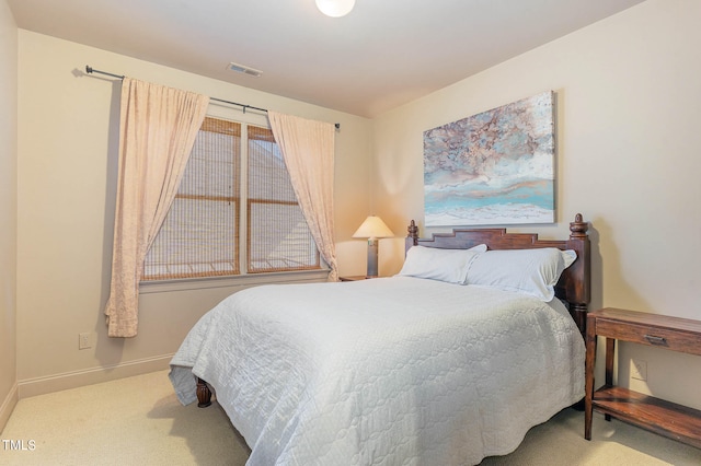 carpeted bedroom with visible vents and baseboards