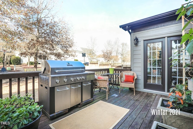 wooden terrace featuring area for grilling